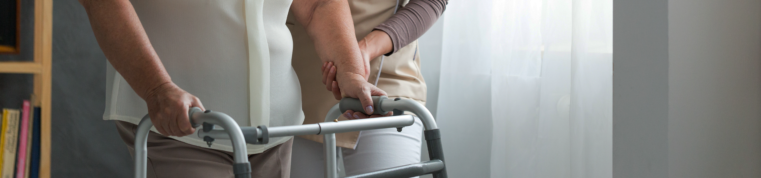 Nurse helping senior with walker