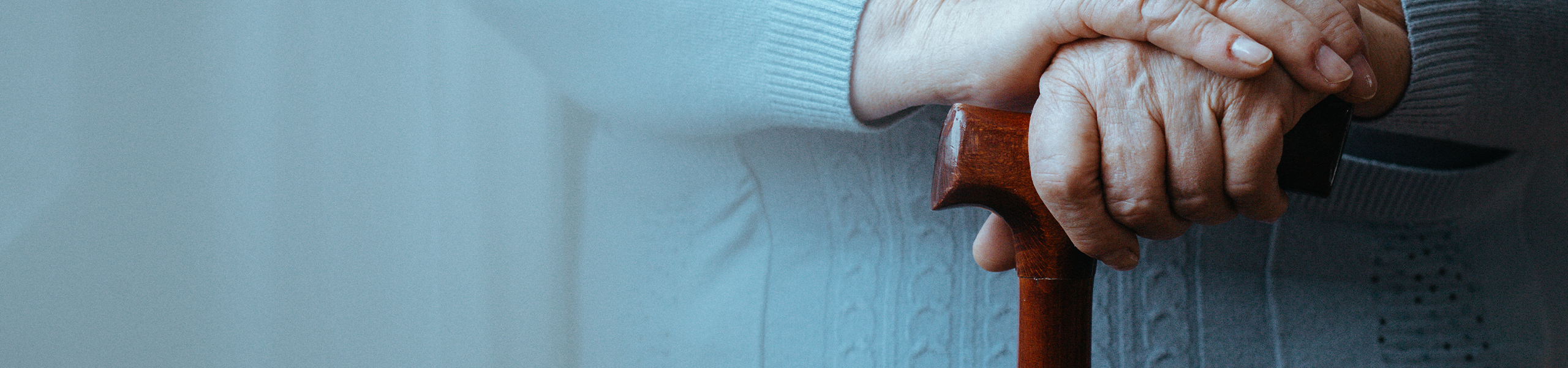 Senior holding wooden cane